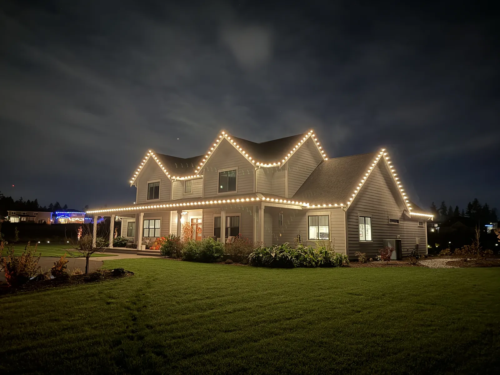 Warm white Christmas lighting on a New England colonial roofline
